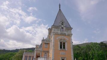 Beautiful view of ancient architecture of palace. Action. Beautiful architecture of palace in European style on background of green forest. European Palace in green mountains in summer video