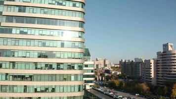 Top view of glass skyscrapers in city on sunny summer day. Stock footage. Beautiful architecture of modern glass skyscrapers. Modern architecture of office high-rises in city video
