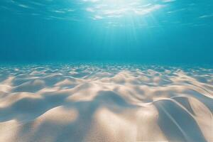 Sunlight glimmers on the sandy ocean floor in a peaceful underwater setting photo
