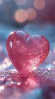 A glowing pink heart shaped decoration surrounded by ice crystals on a frosty surface at twilight photo