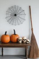 Decorative Halloween display with pumpkins, skulls, and a spider web in a cozy interior setting photo