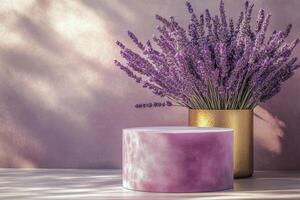 Lavender bouquet in a golden vase beside a round purple pedestal on a wooden table photo