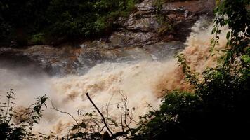 A strong current near a waterfall. Floods flowing in mountain rivers after heavy rains. Flash floods, the effects of global warming and the effects of deforestation. video