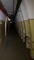 vertical of a corridor inside an underground concrete shelter. fallout video