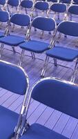 vertical rows of empty blue chairs without spectators video
