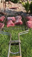 vertical pov a barbecue grill with pieces of meat on a grill with coals video