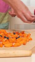 vertical Parent and child cooking together adding blueberries to dessert video