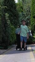 vertical boy dragging a garbage can on wheels. Garbage disposal video
