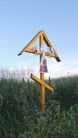 vertical A large wooden Orthodox Christian cross stands in a field video