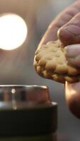 vertical close-up cookie breaks in the hands of a builder, mechanic video