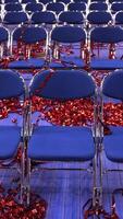vertical red and blue Confetti and tinsel on the floor. rows empty chairs video