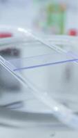 In a laboratory, water is applied to a glass slide for viewing under microscope video