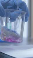 vertical close-up process of analyzing quality of water, liquid in laboratory video