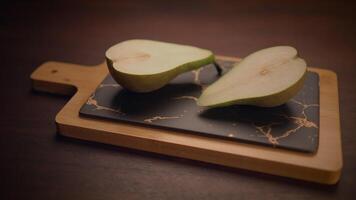 A sliced pear elegantly presented on a stylish cutting board, creating an appetizing scene video