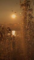 The evening sun sets beautifully through a fountain, creating a charming, dreamy atmosphere video