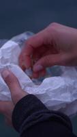Two Hands Gently Holding Crumpled Paper Against a Beautiful and Serene Background Setting video
