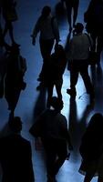 Figures in silhouette are dynamically captured in motion at a lively and vibrant urban setting video
