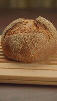 A Beautiful Artisan Bread Sitting on a Rustic Wooden Surface, Ready to Be Enjoyed video