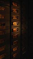 Closeup view of illuminated electrical circuit breakers cast within deep shadows surrounding it video