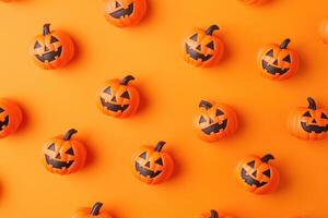 Orange Background with Scattered Jack-o'-Lantern Pumpkins photo