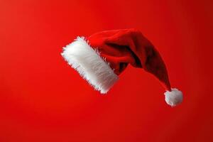 Red Santa Hat with White Fur Trim on a Red Background photo