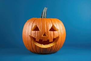 A Carved Jack-o'-Lantern Pumpkin with a Smiling Face on a Blue Background photo