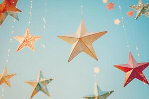 Festive String of Glittering Stars Hanging Against a Blue Sky photo