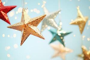 A Golden Star Ornament Hanging Against a Soft Blue Background with Bokeh Lights photo
