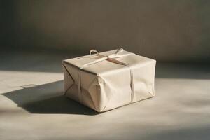 A Simple Brown Gift Box Wrapped in Beige Paper with a White Ribbon photo
