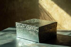 A Silver Gift Box with Embellished Design on a Textured Surface photo