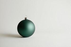 A Single Green Christmas Ornament on a White Background photo