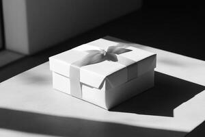 White Gift Box with Silver Ribbon on a White Surface photo