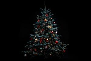 Decorated Christmas Tree with Ornaments and Lights Against a Black Background photo