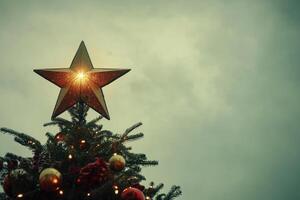 Glittering Star atop a Christmas Tree with Cloudy Sky Background photo