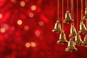 Golden Bells Hanging Against a Red Bokeh Background photo