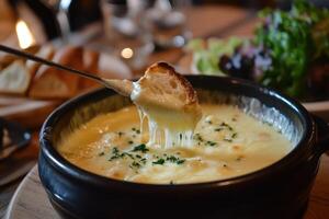 A Piece of Bread Dipped into Melted Cheese Fondue photo