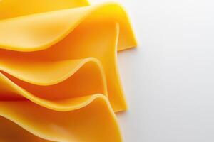 Close-up of Wavy Yellow Cheese Slices on White Background photo