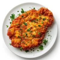 Breaded and fried cod fillet, served on a white plate. photo