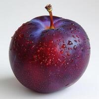 An apple with water droplets on its surface, indicating recent rainfall. photo