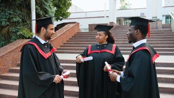 African American and Indian graduates in the mantles talking at university campus video