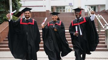 Graduates running in campus and celebrating graduation video