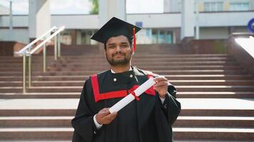 Portrait of Pakistani student with diploma near university video