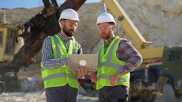 Team Engineers in hardhat and uniform use laptop to plan the work of a quarry video
