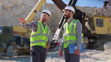 Construction workers engineers are talking at the quarry mining site video