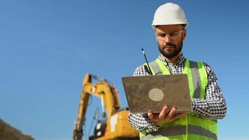 Engineer geologist using laptop in quarry video