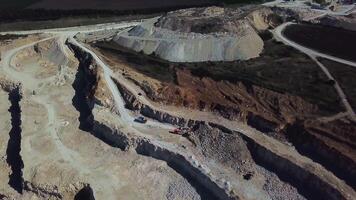Excavator loads ore into a large mining dump truck. Open pit video