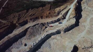 Excavator loads a dump truck with soil. The excavator digs the ground at the construction site. Removal of soil from a construction site or quarry video