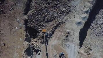 Loading of stone into truck. Excavator at work. Quarry mining video