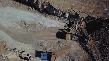 Loading of stone into truck. Excavator at work. Quarry mining video