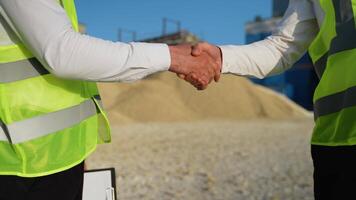 Two men engineers shaking hands at quarry video